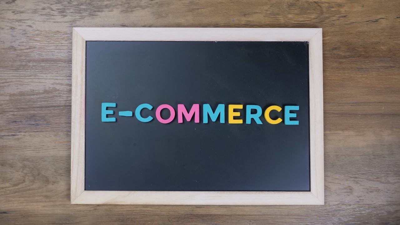 services-01 Colorful letters spelling 'e-commerce' on a wooden framed blackboard.